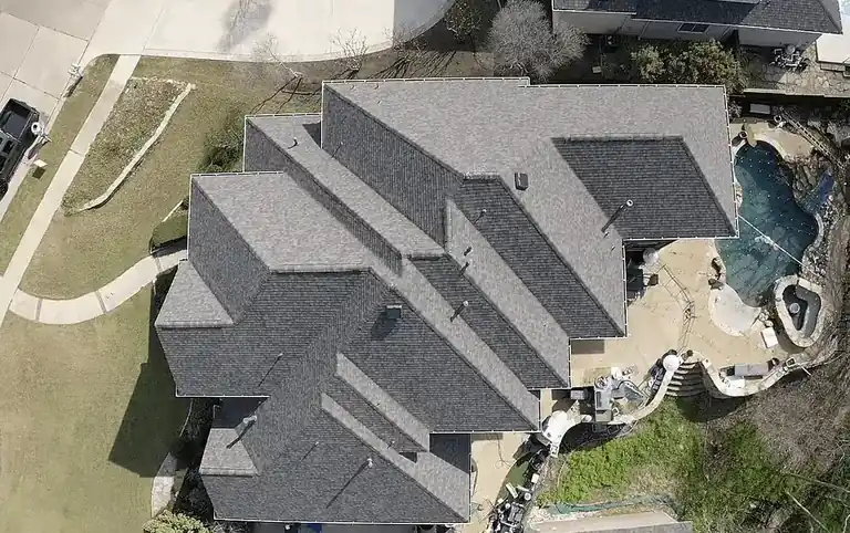 Aerial view of a residential shingle roof in North Texas